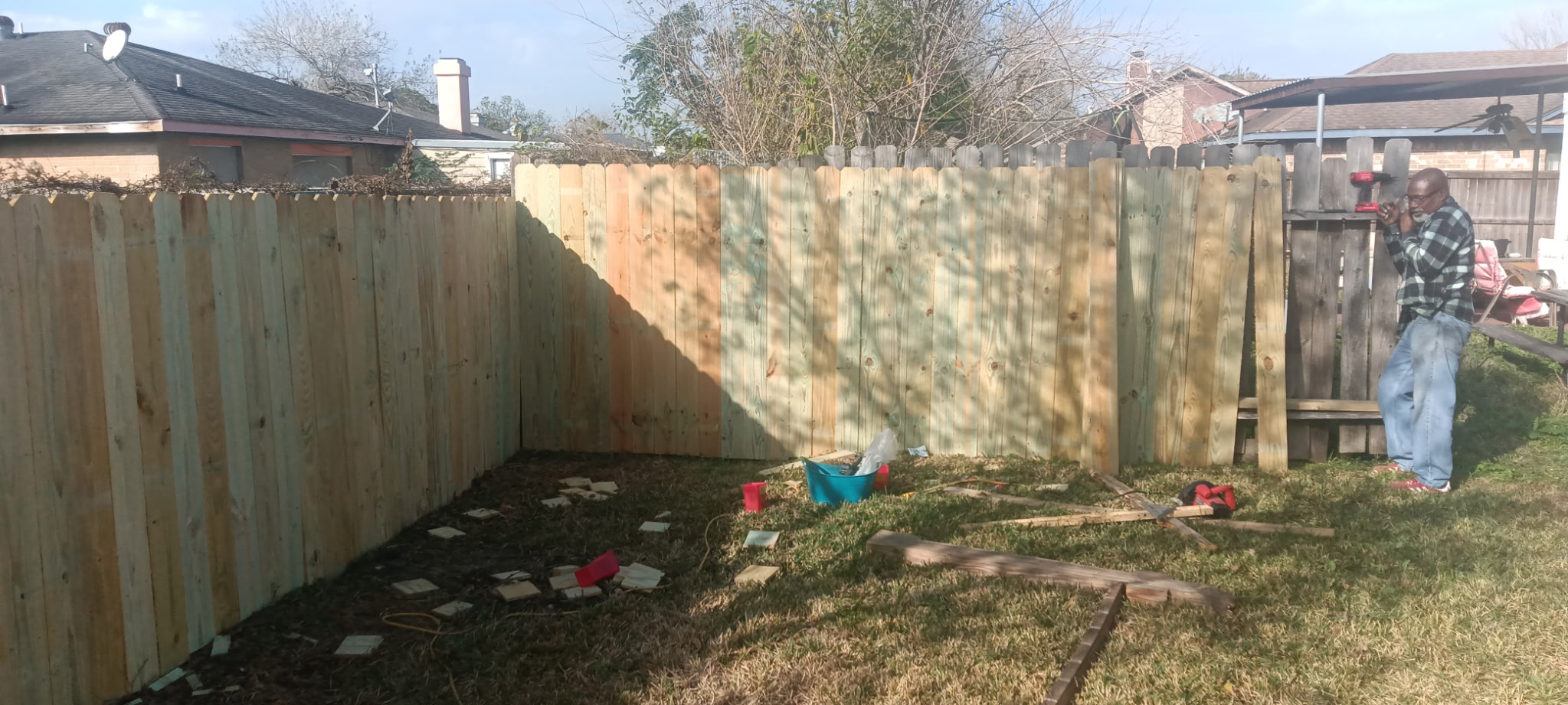 Completed cedar fence wrapping around a backyard corner